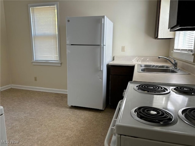 kitchen featuring sink and white appliances