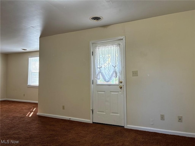 foyer with dark colored carpet