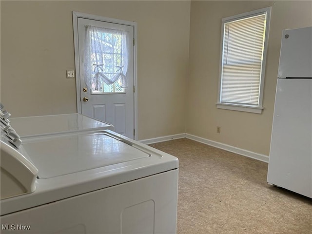 washroom featuring washer and clothes dryer