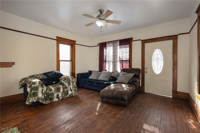 living room with dark wood-type flooring, a wealth of natural light, and ceiling fan