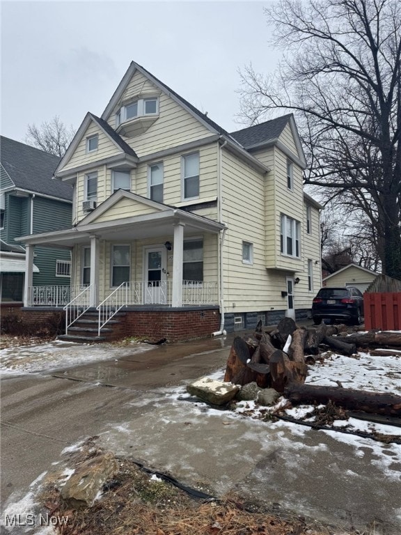 american foursquare style home featuring a porch