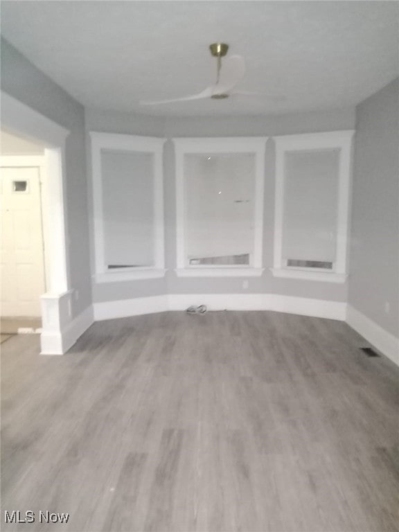 unfurnished room featuring wood finished floors and baseboards