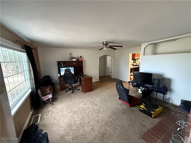 office featuring ceiling fan, carpet floors, and a textured ceiling