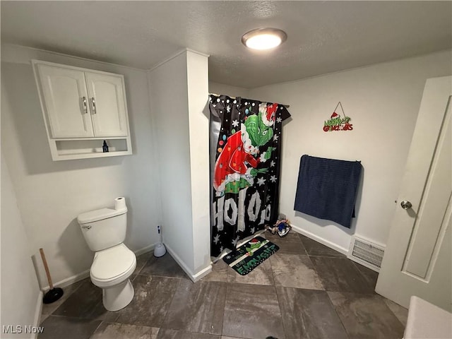 bathroom with toilet and walk in shower