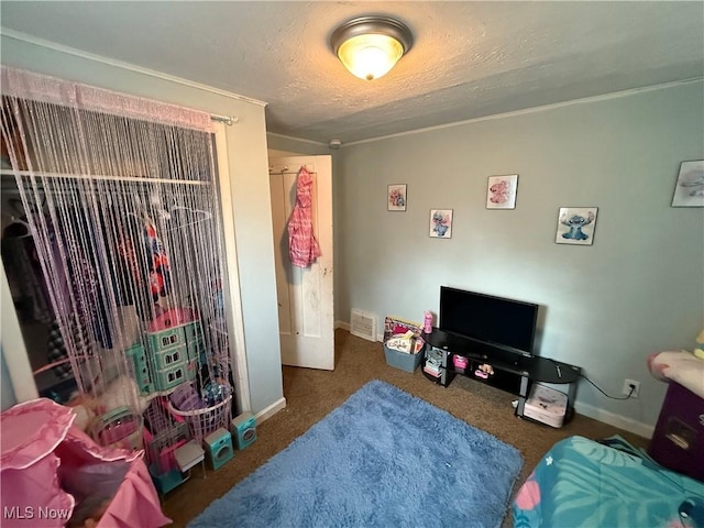 bedroom with a textured ceiling and dark colored carpet