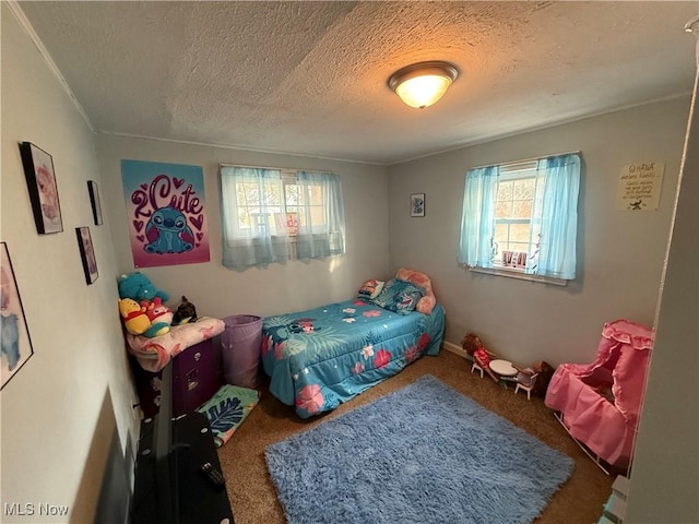 carpeted bedroom featuring a textured ceiling