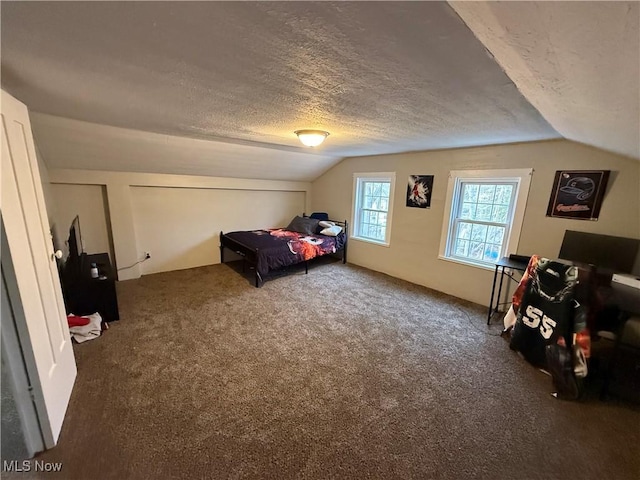 carpeted bedroom featuring vaulted ceiling and a textured ceiling