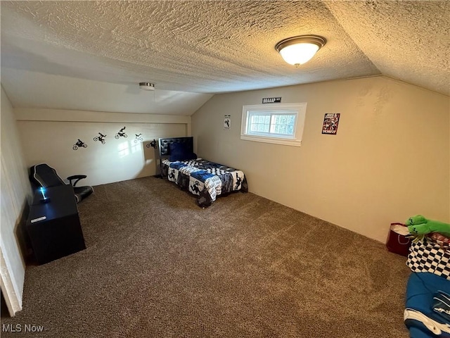 unfurnished bedroom featuring vaulted ceiling, a textured ceiling, and carpet