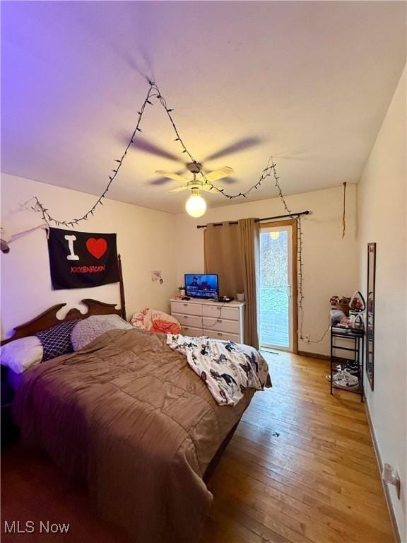 bedroom featuring access to exterior, light hardwood / wood-style flooring, and ceiling fan