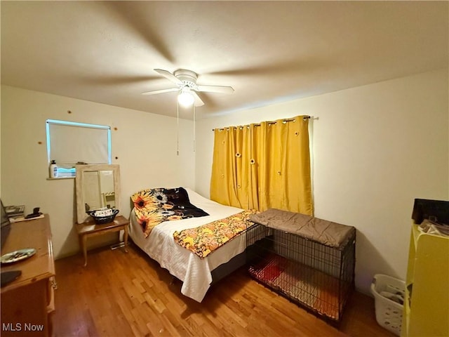 bedroom with hardwood / wood-style floors and ceiling fan