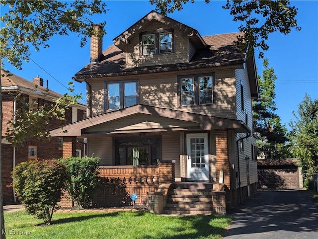 craftsman house with an outbuilding, a garage, and covered porch