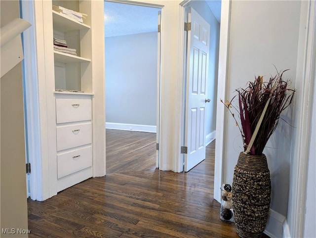 hall with baseboards and dark wood finished floors