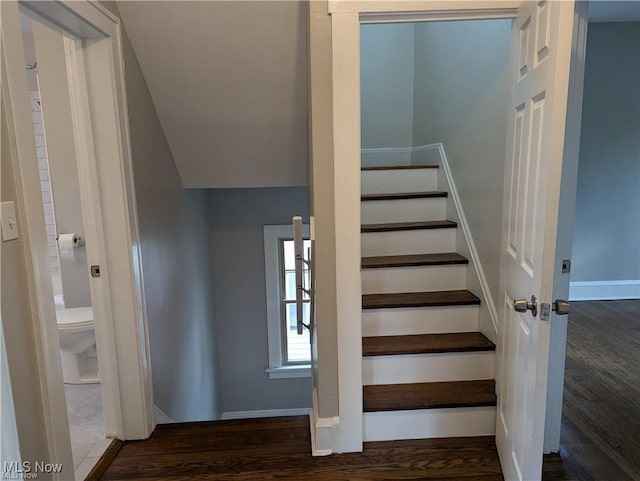 stairs featuring baseboards and wood finished floors
