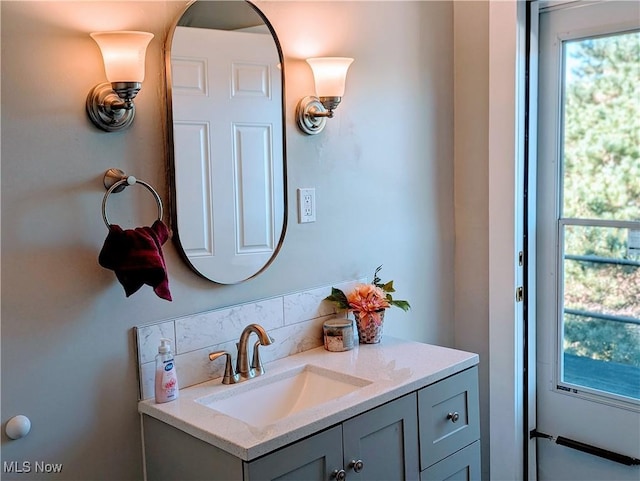 bathroom with tasteful backsplash and vanity