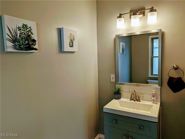 bathroom featuring vanity and backsplash