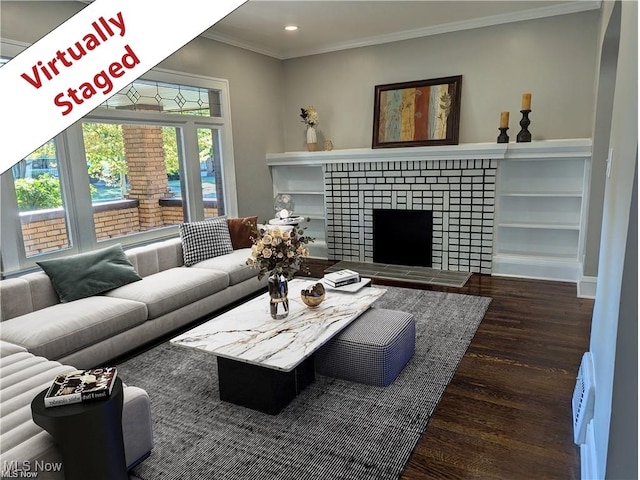 living room with crown molding, recessed lighting, wood finished floors, and a tile fireplace
