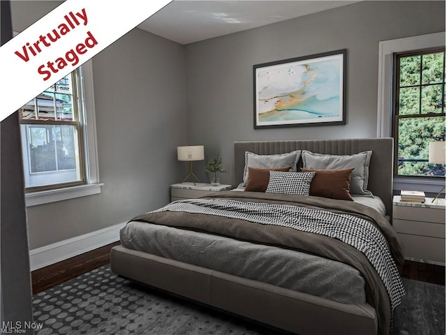 bedroom featuring baseboards and wood finished floors