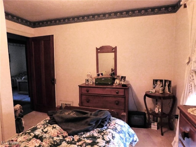 bedroom featuring light colored carpet