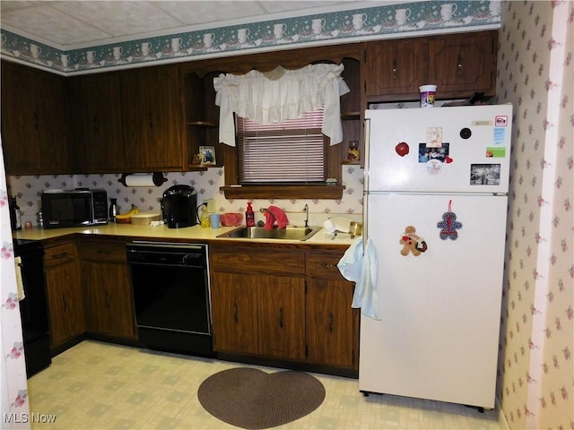 kitchen with dark brown cabinets, sink, and black appliances