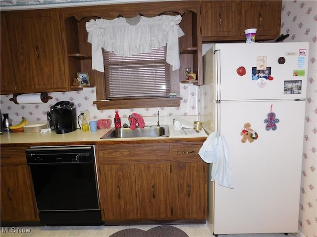 kitchen featuring sink, white fridge, and dishwasher