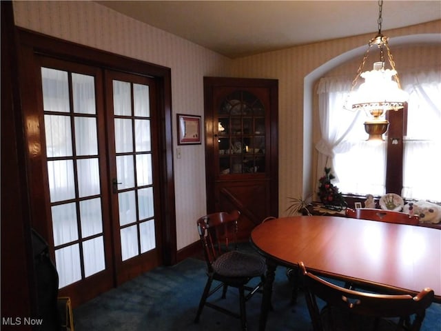 dining area featuring french doors and carpet floors