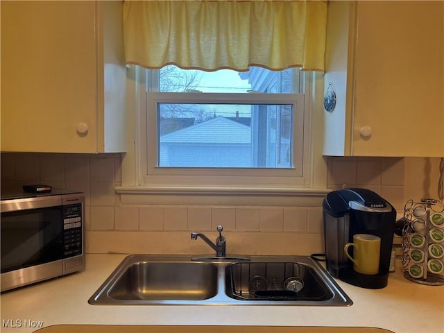 kitchen with tasteful backsplash and sink