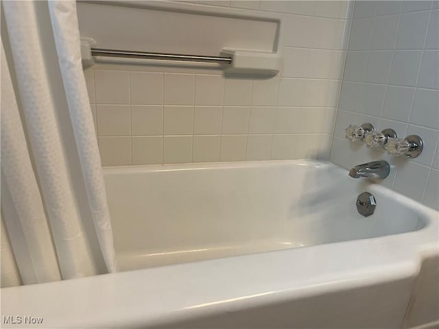 bathroom with shower / tub combo