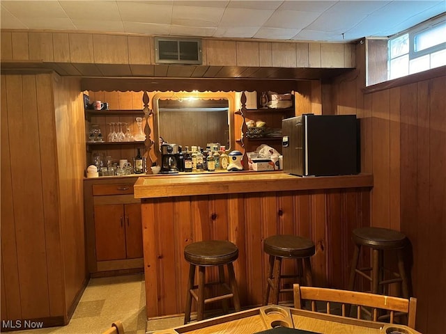 bar featuring wood walls