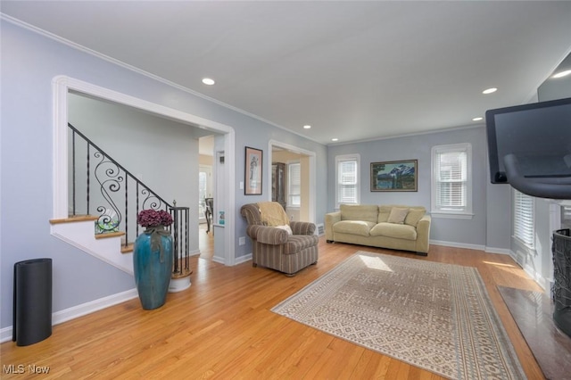 living room featuring crown molding and hardwood / wood-style floors