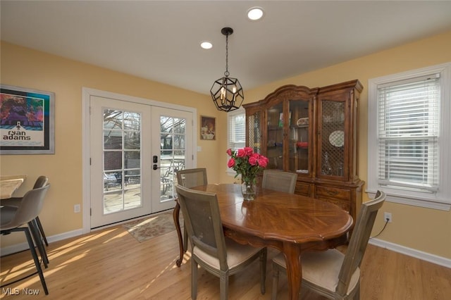 dining room featuring french doors and light wood-type flooring