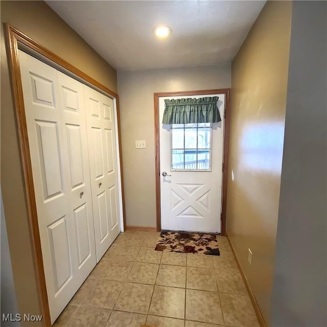 doorway to outside featuring light tile patterned flooring