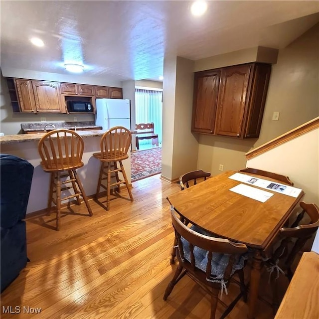 dining space with light wood-type flooring