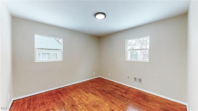 unfurnished room featuring hardwood / wood-style floors