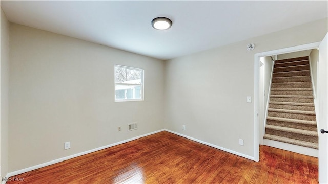 spare room with hardwood / wood-style flooring