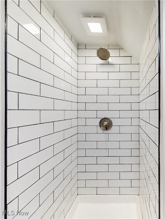 bathroom with a tile shower