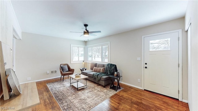 living room featuring hardwood / wood-style flooring and ceiling fan