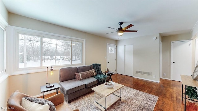 living room featuring dark hardwood / wood-style floors and ceiling fan