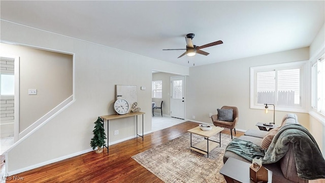 living room featuring ceiling fan and hardwood / wood-style floors