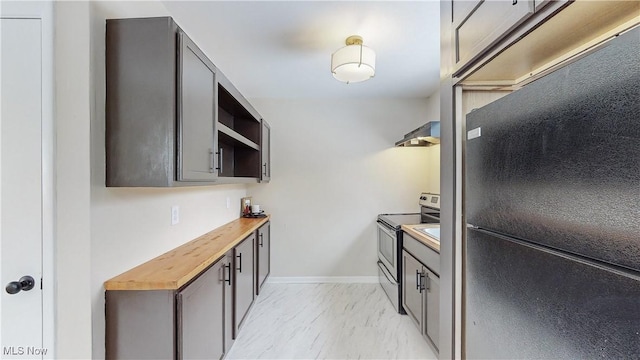 kitchen featuring black refrigerator, wooden counters, and electric stove