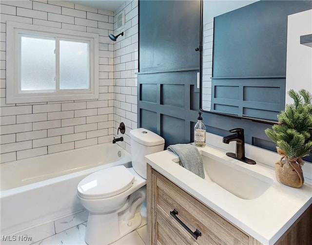 full bathroom featuring tiled shower / bath, vanity, and toilet