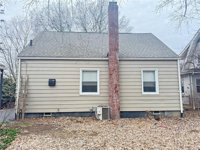 back of house with central air condition unit