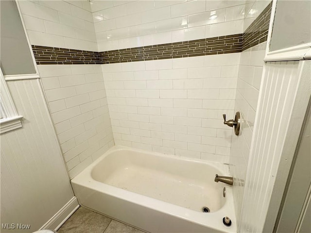 bathroom with tile patterned flooring and tiled shower / bath