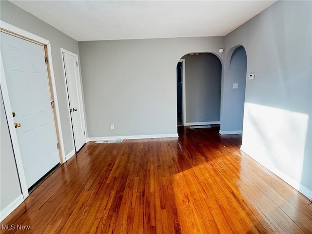 spare room with wood-type flooring