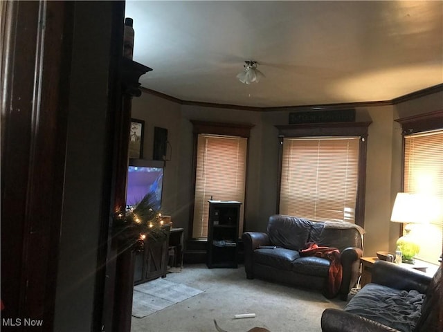 living room with crown molding and light colored carpet