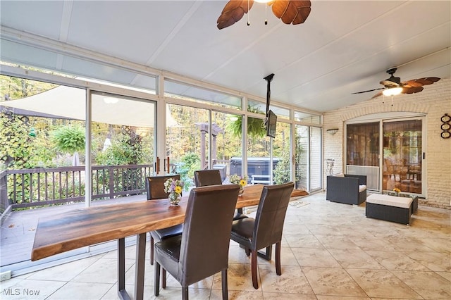 sunroom featuring ceiling fan and lofted ceiling