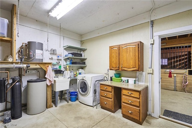 clothes washing area featuring cabinets and washing machine and clothes dryer