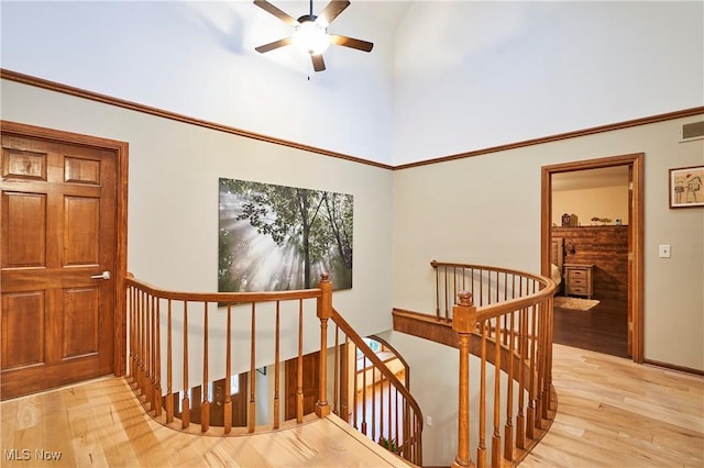 hall featuring a high ceiling and light hardwood / wood-style floors