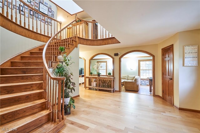 foyer featuring light hardwood / wood-style floors and a skylight