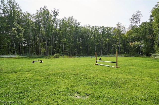 view of property's community with a rural view and a yard