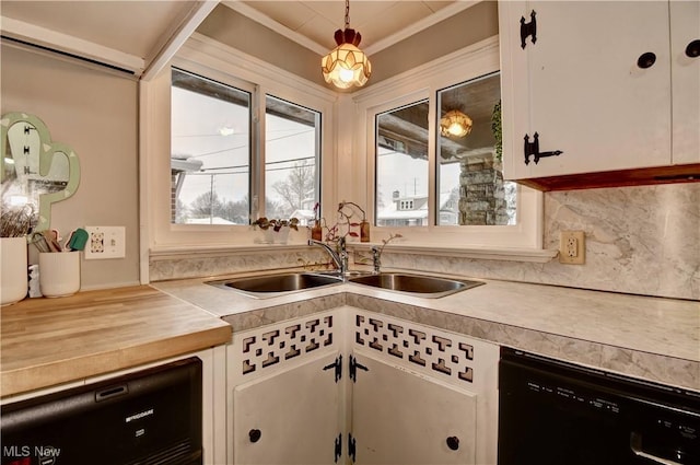 kitchen with decorative light fixtures, sink, black dishwasher, and white cabinets